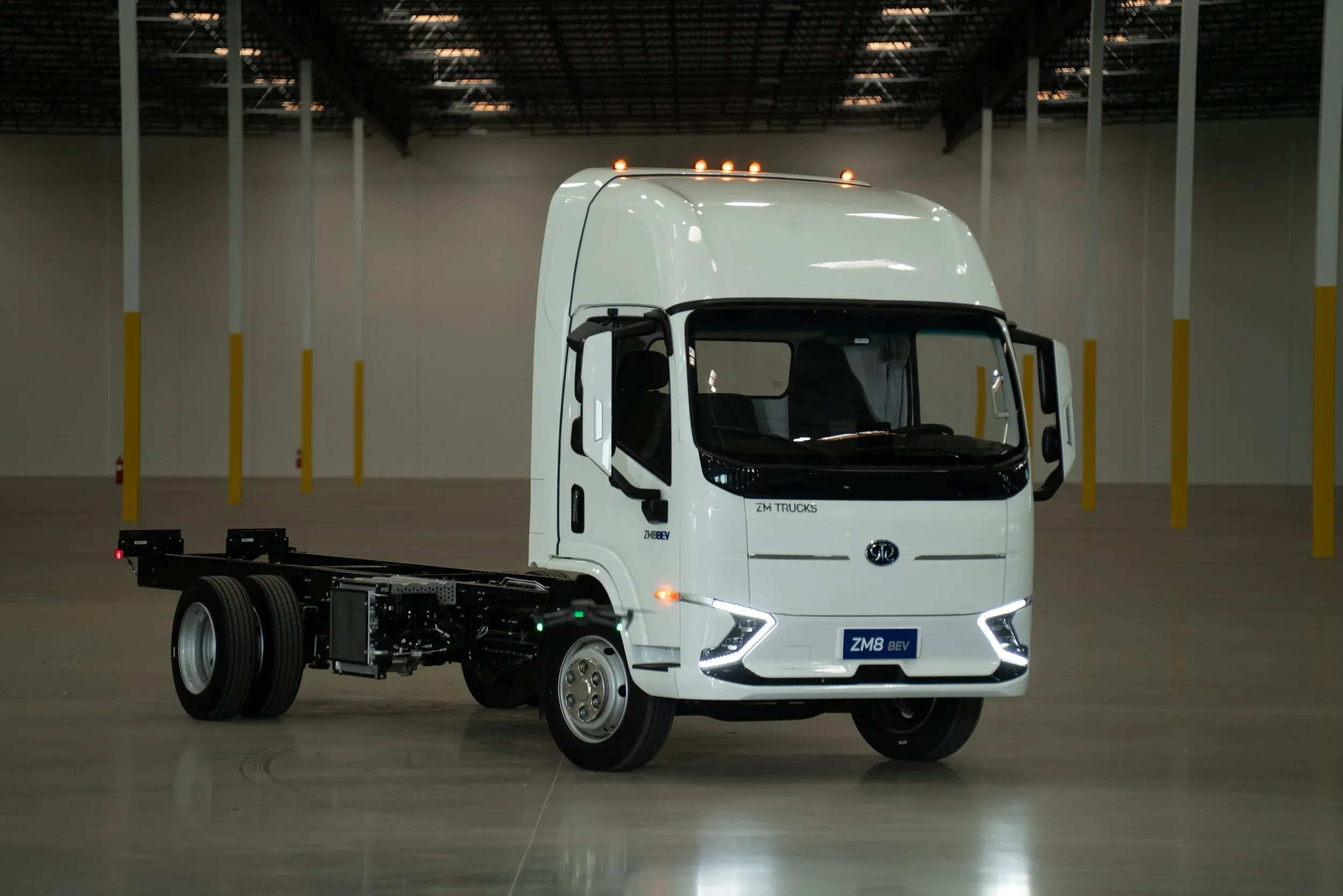 White electric truck in an empty warehouse